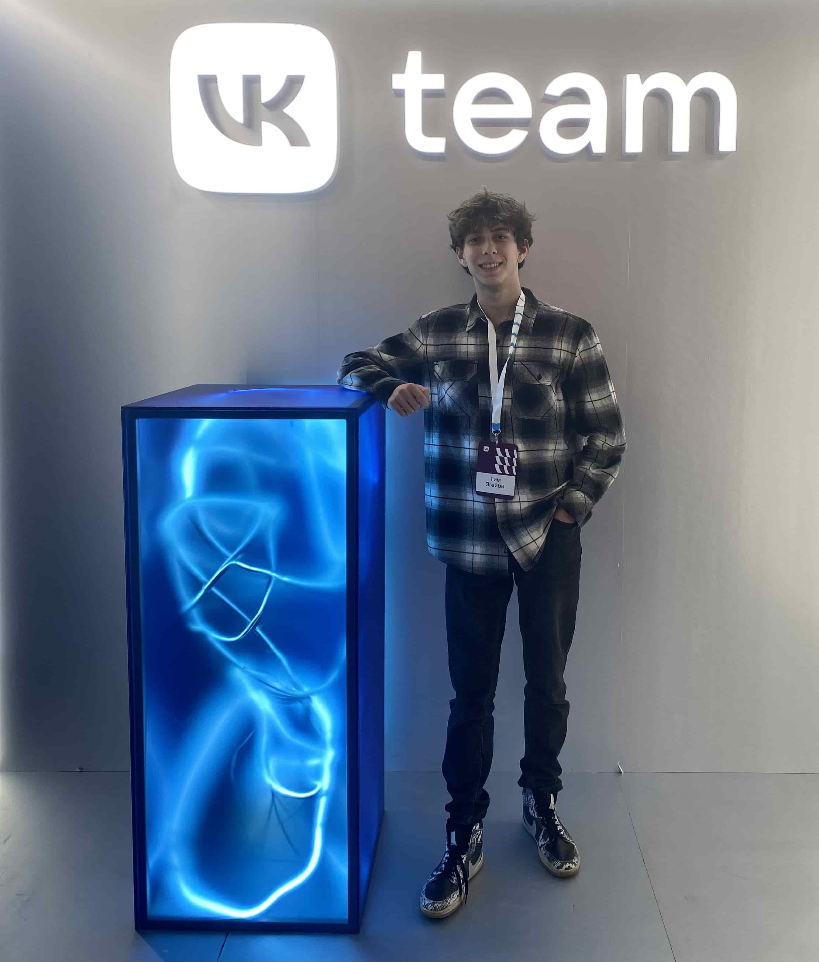 Me standing in front of VK TEAM logo